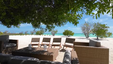 dream outdoor space ready for summer season with table, bench and chairs beachfront home, los roques