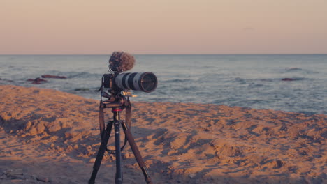 camera and tripod at the beach