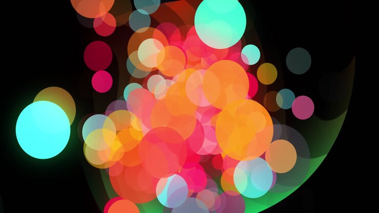 Animazione di punti colorati su forme a spirale arancioni e verdi su sfondo nero.