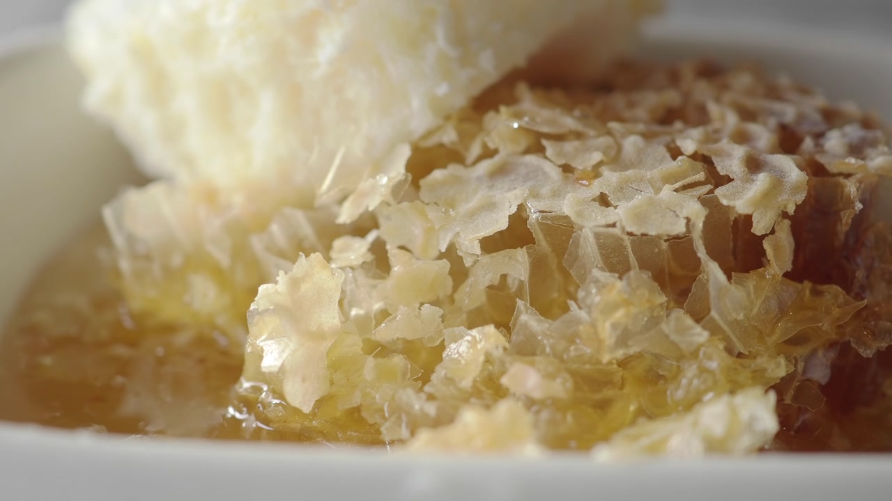 Close-up of Natural Honeycomb with Golden Honey and Beeswax