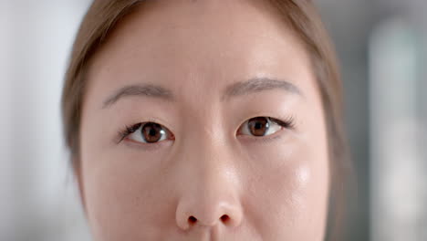 close-up of a young asian woman's face, with copy space