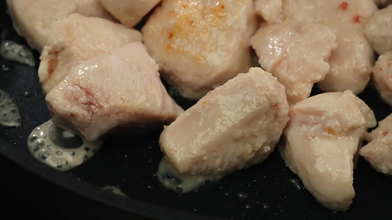 Man slicing raw turkey or chicken meat fillet on oak cutting board closeup, cooking with knife on restaurant kitchen. High quality 4k footage