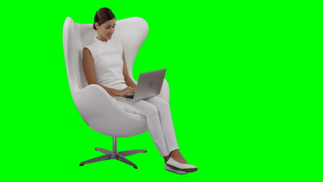 a woman sitting and using laptop