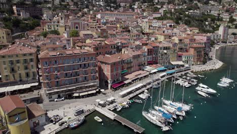 Villefranche-Sur-Mer-Boat-and-Yacht-Harbor-on-Tropical-French-Riviera-Coastline-in-Nice,-France---Aerial