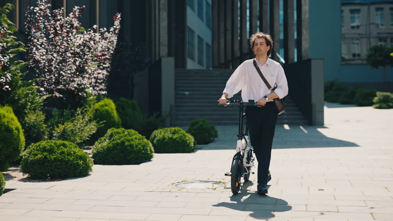 Man walking with folding electric bike in urban environment