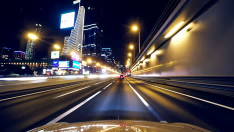 night driving on a city highway through a tunnel