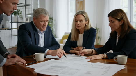 business professionals discussing documents at a meeting