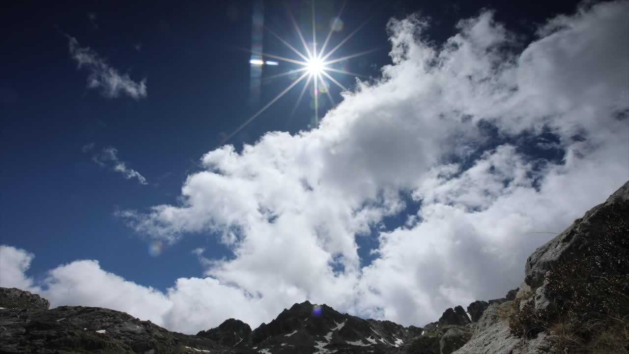Mountain landscape with clouds and sun