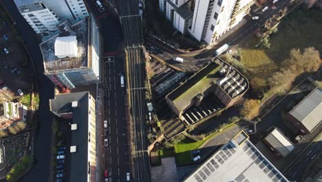 aerial drone flight showing a birdseye view of the railway line from deansgate station to oxford road train station in manchester city centre