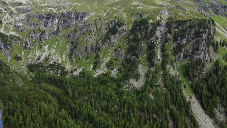 Steep-gravel-slope-covered-in-stones-and-a-few-trees-in-the-Alps-in-Kaernten,-Austria