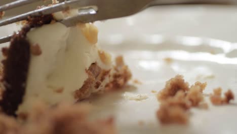 Fresh-carrot-cake-with-icing-eating-with-fork-macro-shot