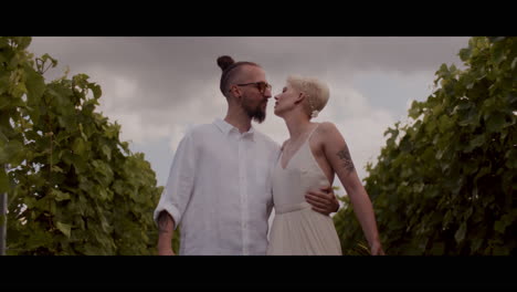 romantic couple kissing in vineyard
