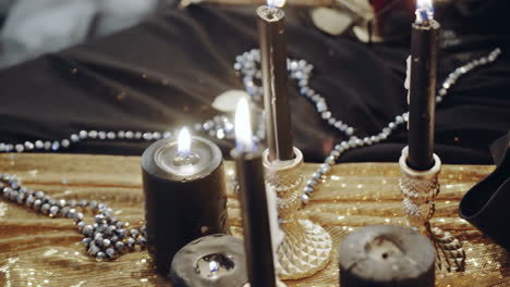 Witch at table. Portrait of woman dressed in witch style sitting by the table