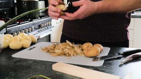 Man-Peels-His-Potatoes-For-His-Family-Dinner