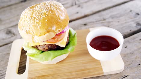 hamburger and tomato sauce on chopping board