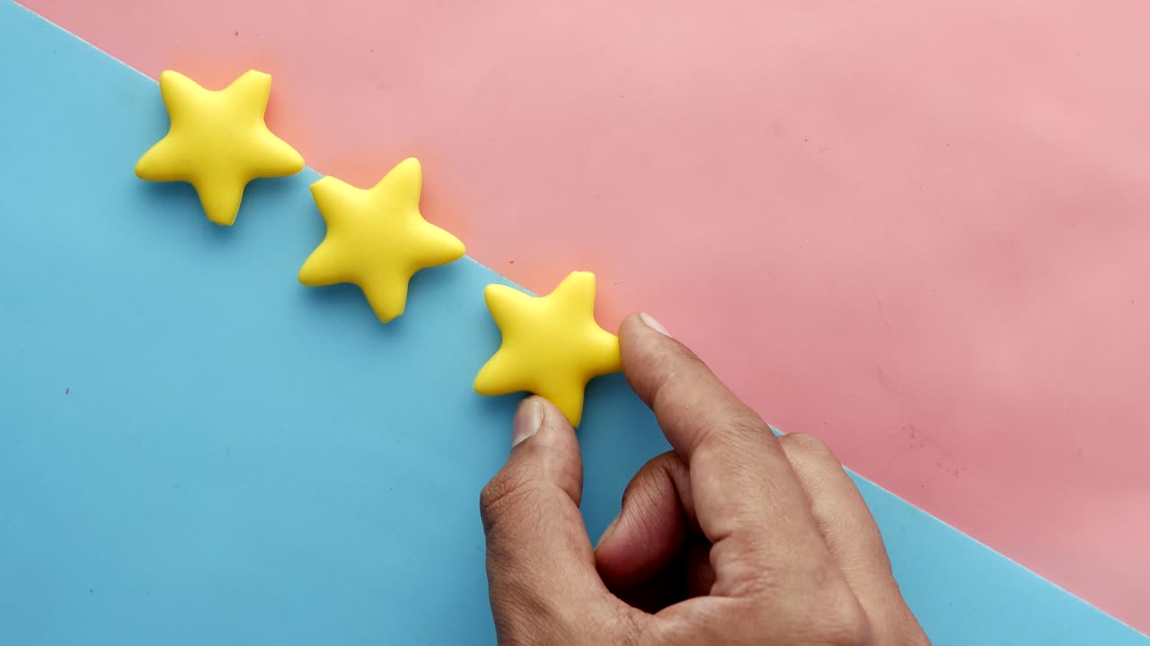 Three Yellow Stars on a Pastel Background