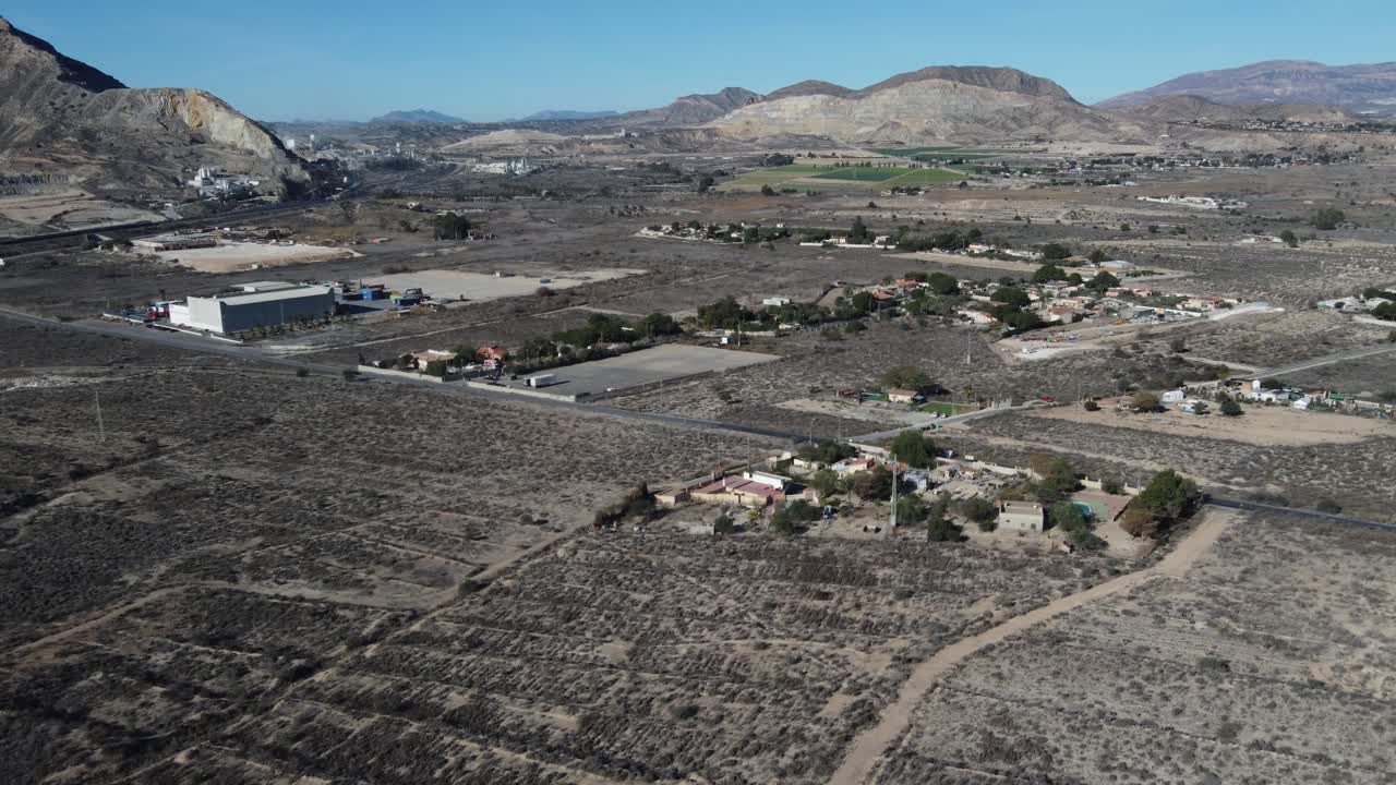 Aerial view of a lonely car driving in a desertic landscape. Fontcalent area, Alicante, Spain.