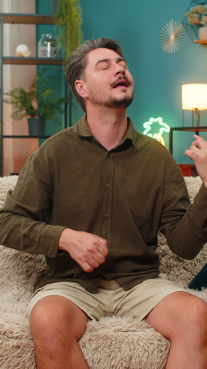 Middleaged man strumming air guitar energetic riff lively playful moves enjoying rock rhythm vibe