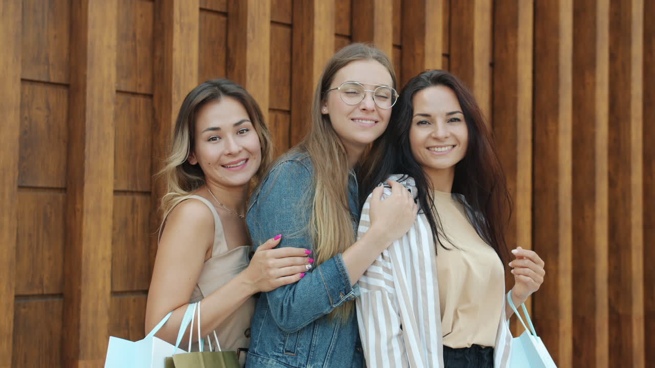 Three happy friends enjoying shopping