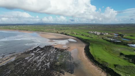 aerial rising shot showing doughmore bay with trump doonbeg alongside