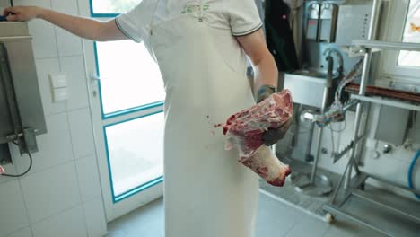 Butcher-Using-Saw-To-Cut-Through-Lamb-Bone-In-Factory