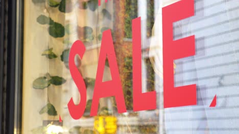 red sale sign in a storefront window