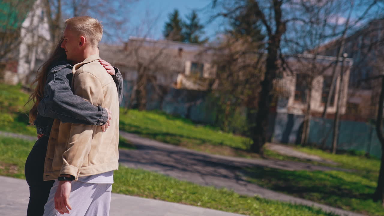 Happy couple in love holding hands of each other while spending time together in the park. Romantic date concept