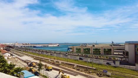 view of the train tracks and the road to the seafront of algiers with the port in the background