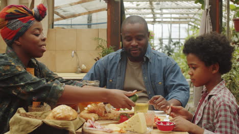 afro family enjoying meal at farm