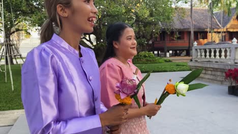 people making offerings at a thai temple