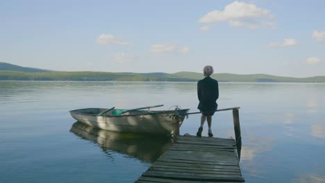 person standing on a dock overlooking a lake