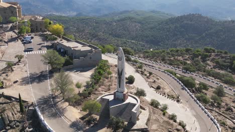 aerial orbital around statue of our lady of cabeza in scenic andalusia landscape spain