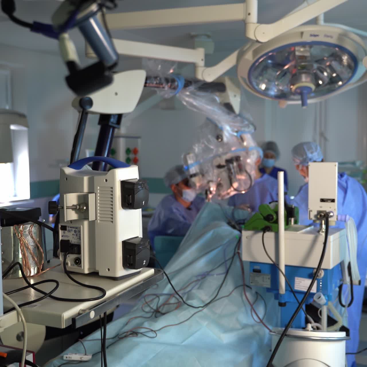 Neurosurgeons perform operation in operational theatre. Gradual movement from the doctors up to the equipment in surgery room