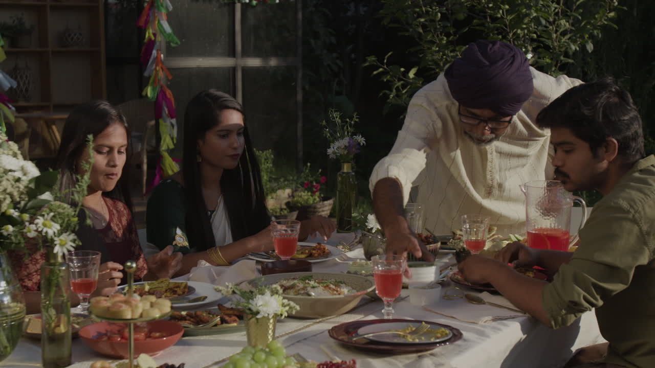 South Asian Family Enjoying an Outdoor Dinner Together