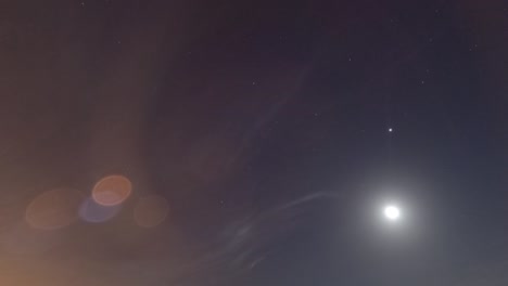 rising moon light ray n star with bokeh lens flare on dark night sky timelapse