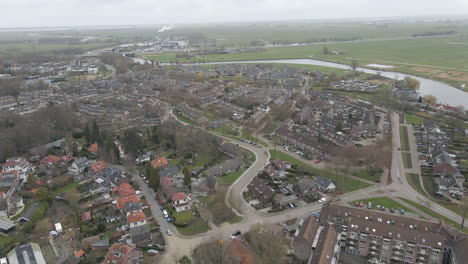 aerial of suburban neighborhood in small dutch town near river