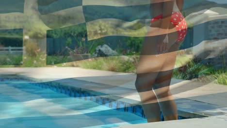 animation of flag of greece over midsection of biracial woman walking into swimming pool