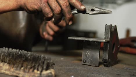 hands of welder working on a piece of metal