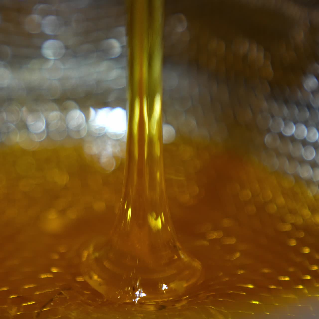 Sweet golden honey pouring. Healthy organic food dripping in macro shot