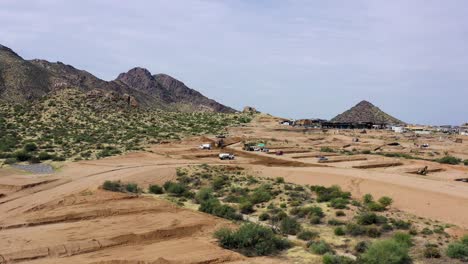 Aerial,-slow-rotation,-and-push-in-on-Sonoran-Desert-construction-site