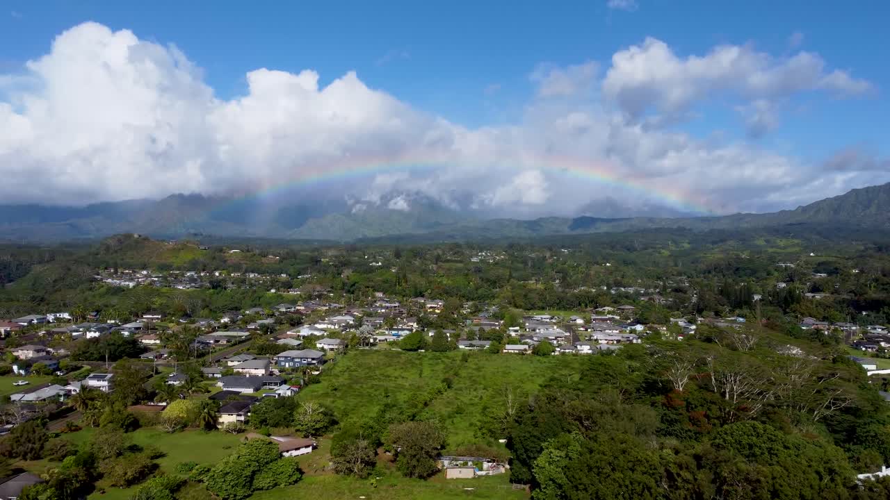vista aérea cinematográfica del arco iris en el cielo nublado en kauai, hawai, estados unidos