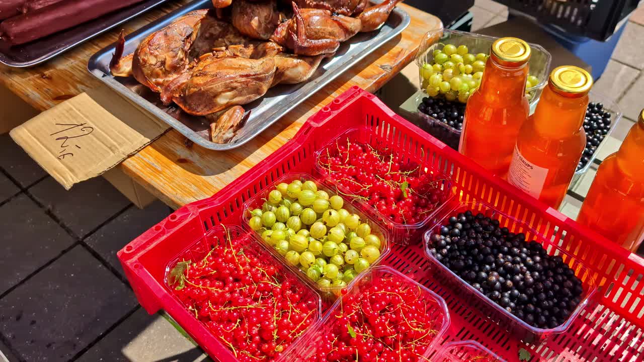 View of cherries and roasted chicken on a table during daytime