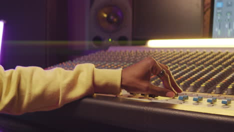 African-American-Man-Working-with-Mixing-Console-in-Recording-Studio
