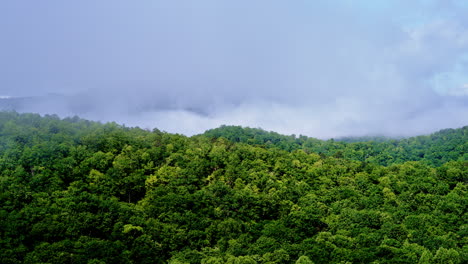 Aerial perspective of mist slowly engulfing mountain peaks