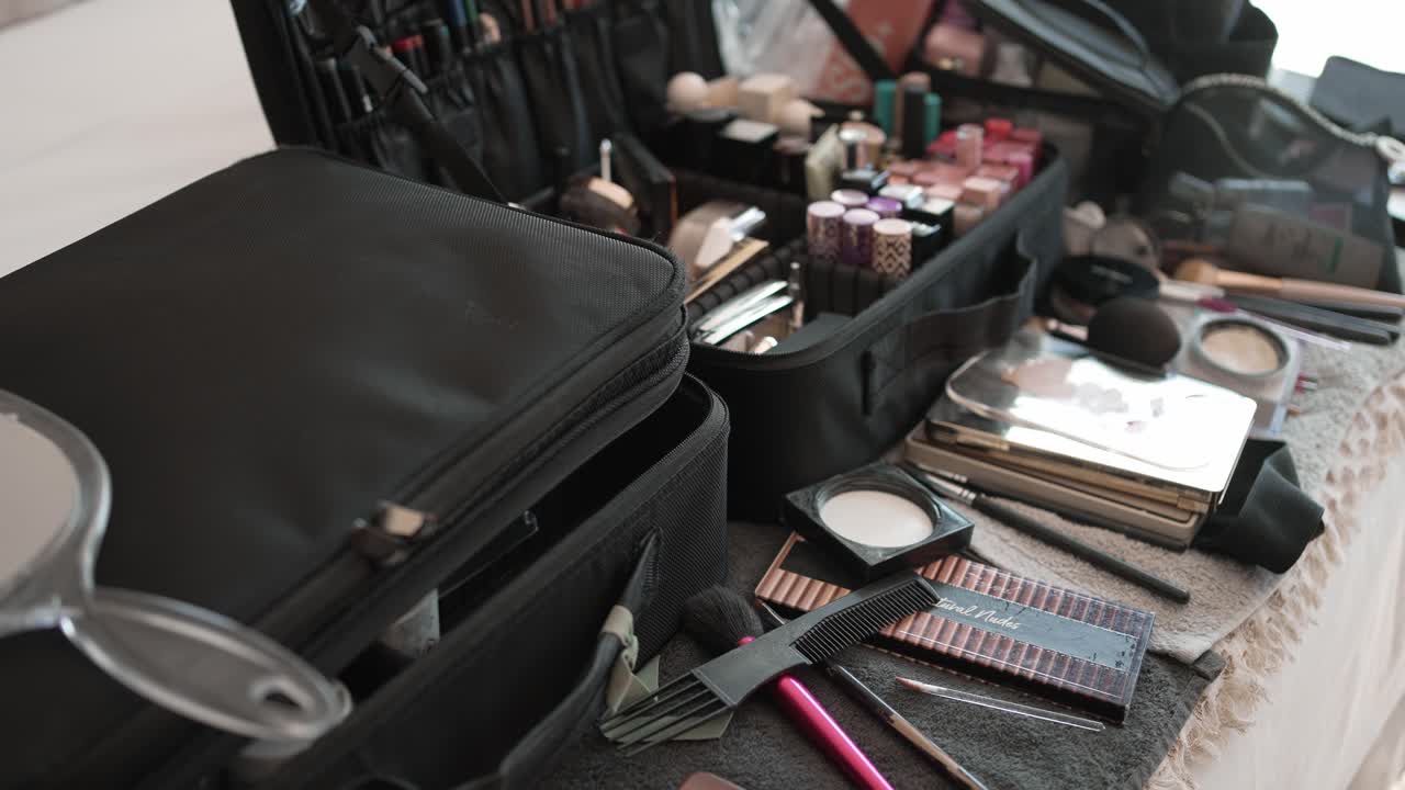 makeup artist’s kit, full of various beauty products and tools laid out