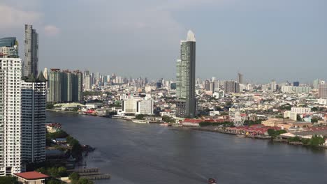 modern skyline of bangkok city with skyscrapers next to chao phraya river