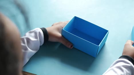 top view of child open a empty small gift box