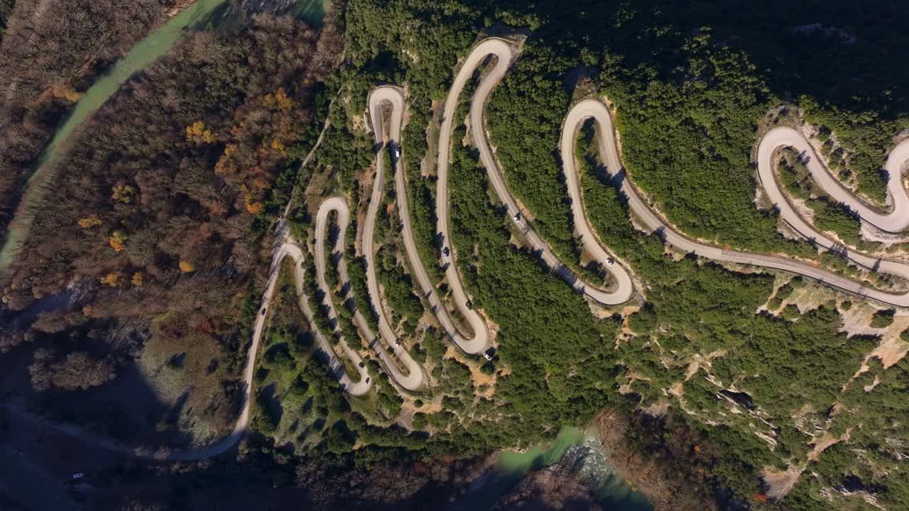 Aerial glimpse of road weaving through forest hills, Epirus, Greece