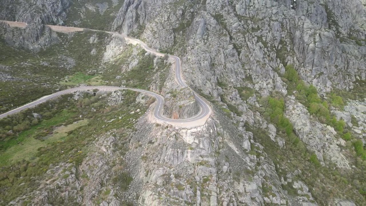 Riprese aeree con drone della Serra da Estrela, Portogallo: cime montuose rocciose, bacini idrici e vasto paesaggio naturale sotto una luce chiara. Ideale per progetti di viaggio e natura