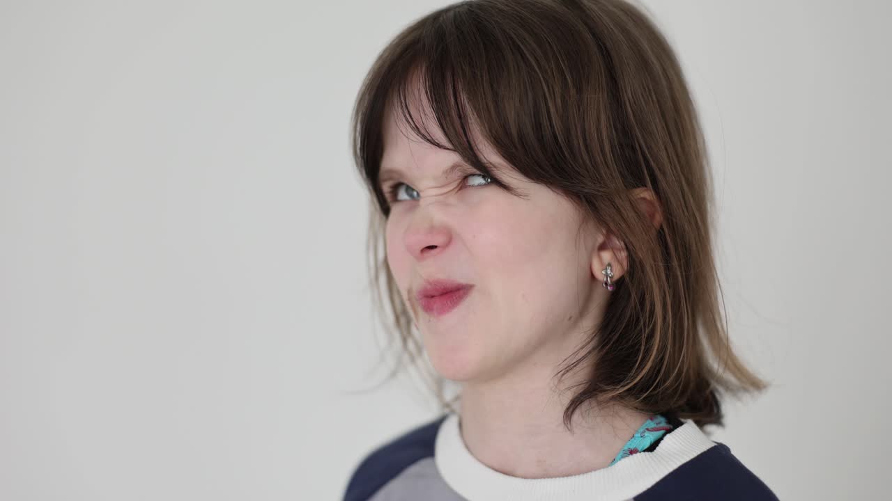 Young Girl Making Disgusted and Thoughtful Expressions